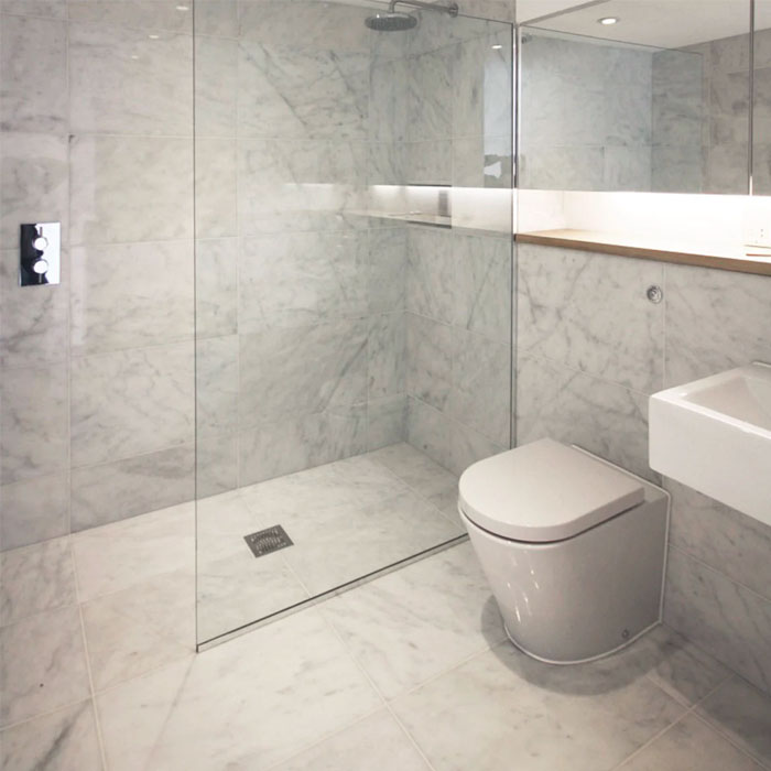 Ibiza Bianco honed marble tiled bathroom